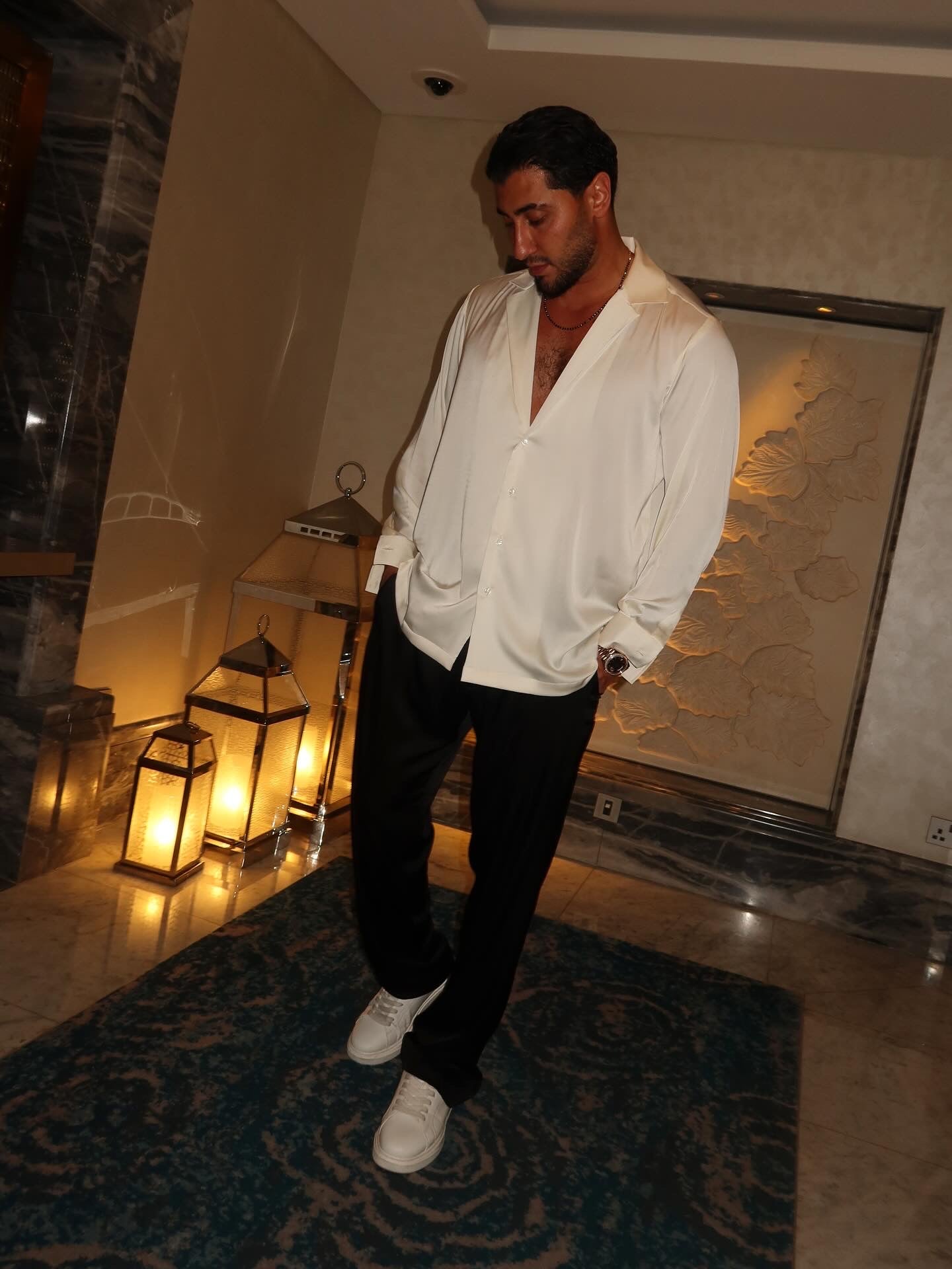 black silk trousers and a white silk shirt