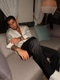 black silk trousers and a white silk shirt
