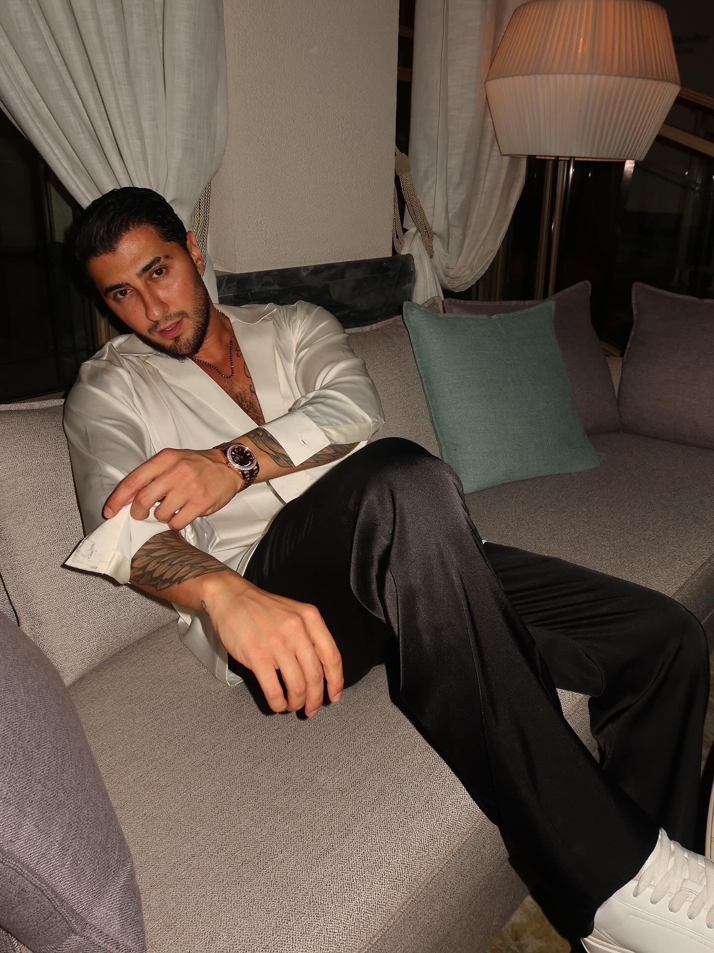 black silk trousers and a white silk shirt