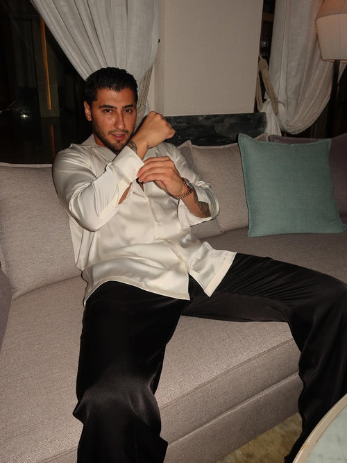 black silk trousers and a white silk shirt