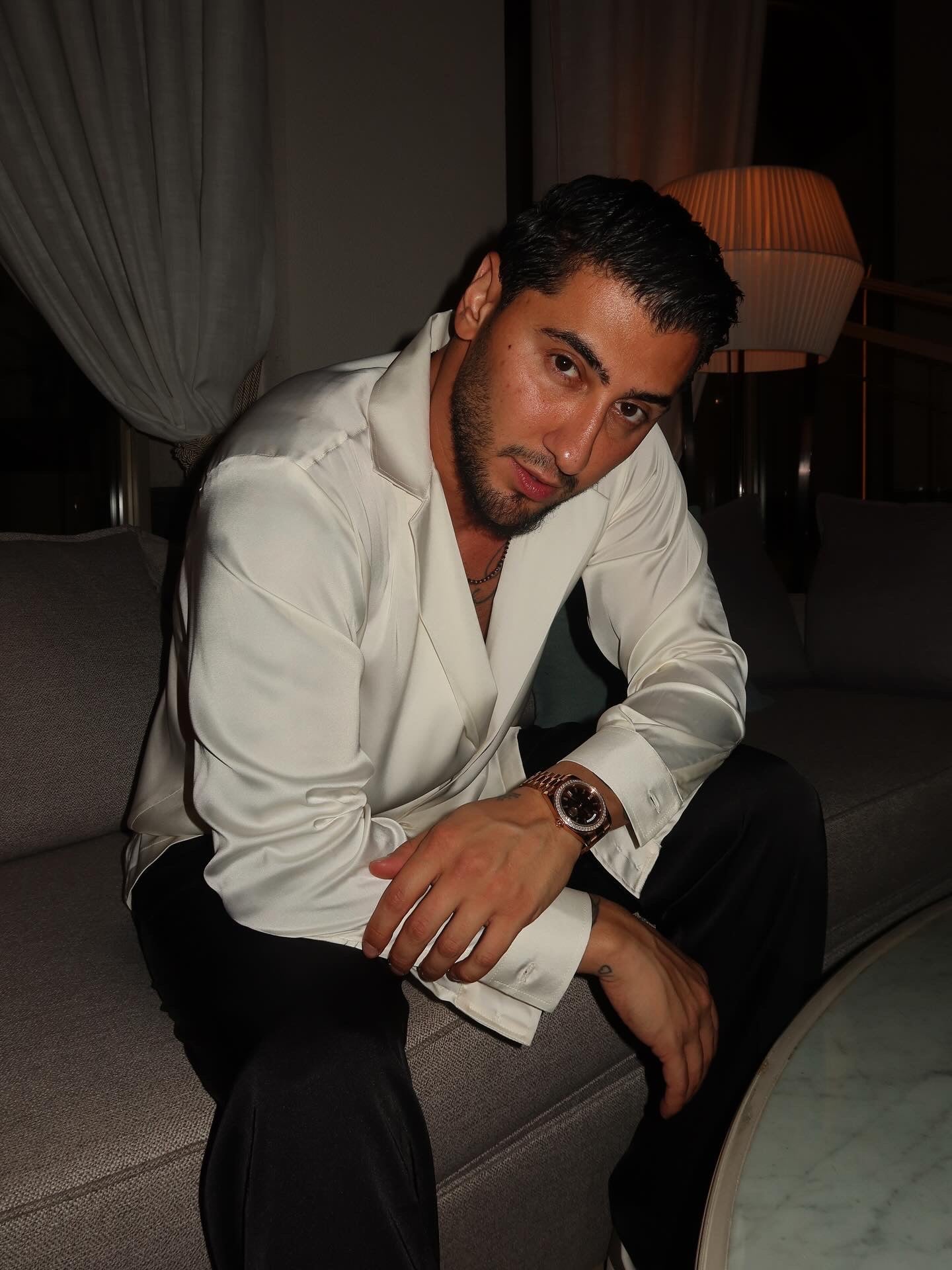 black silk trousers and a white silk shirt