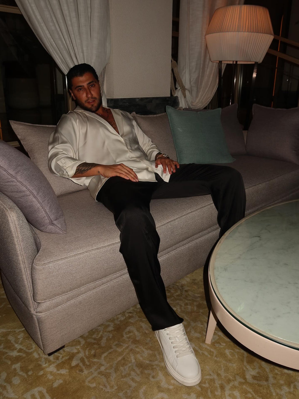 black silk trousers and a white silk shirt