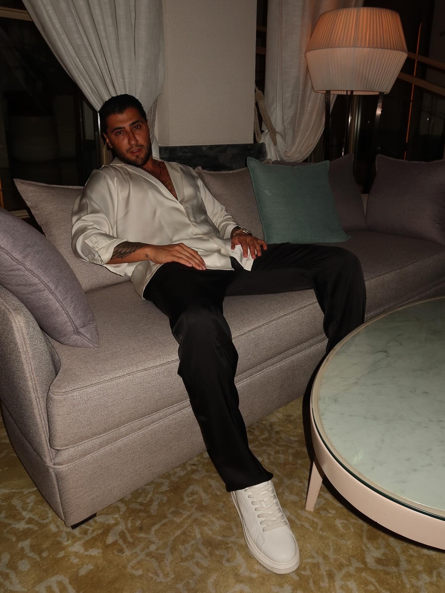 black silk trousers and a white silk shirt