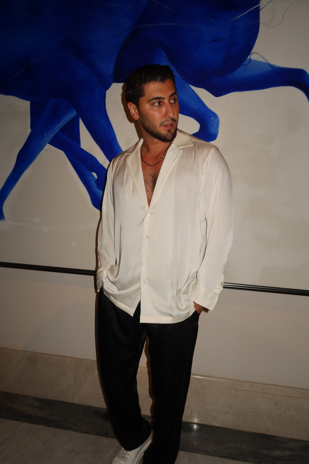 black silk trousers and a white silk shirt