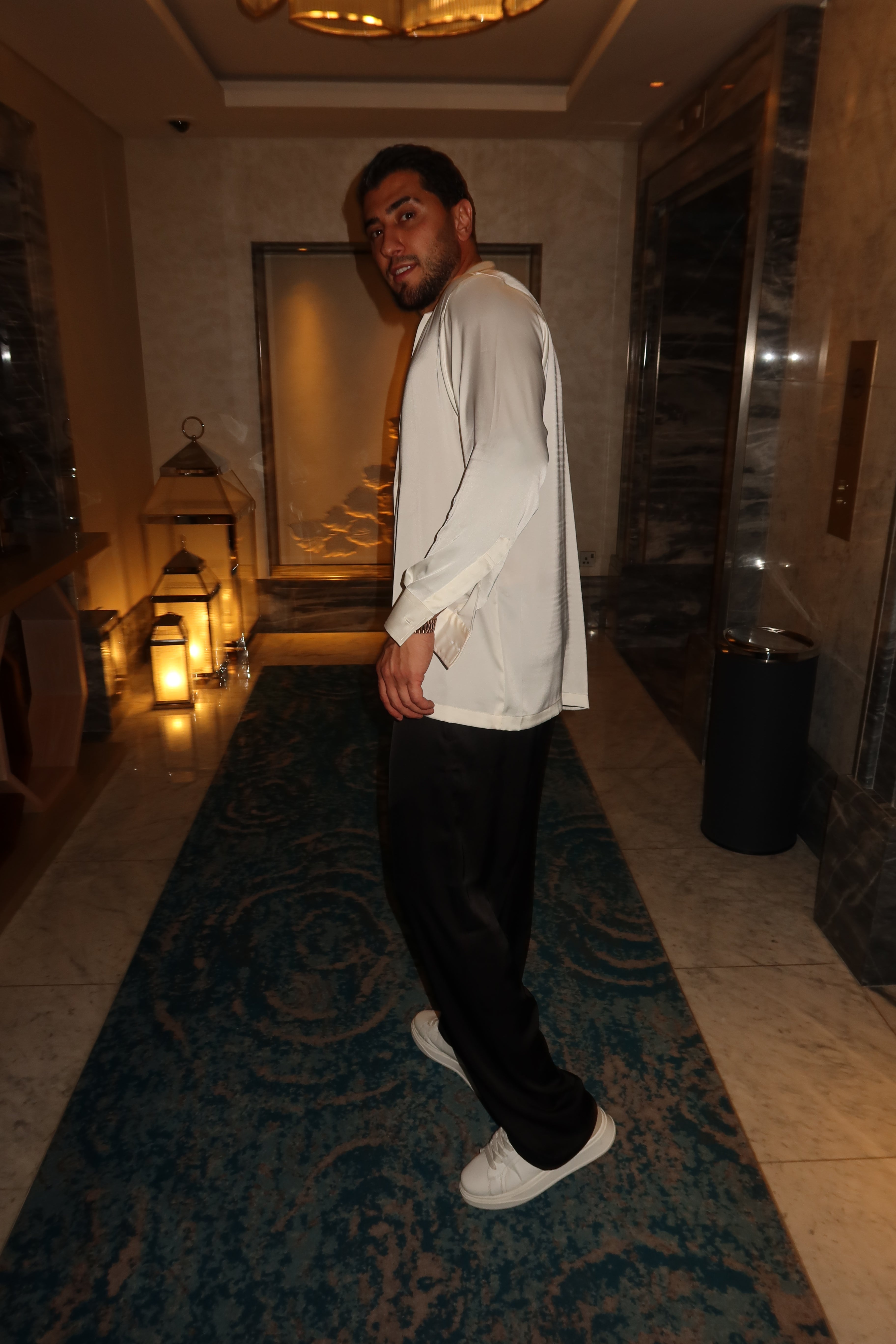 black silk trousers and a white silk shirt